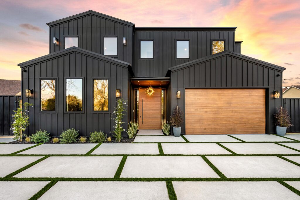 contemporary black house exterior with wooden garage door.
