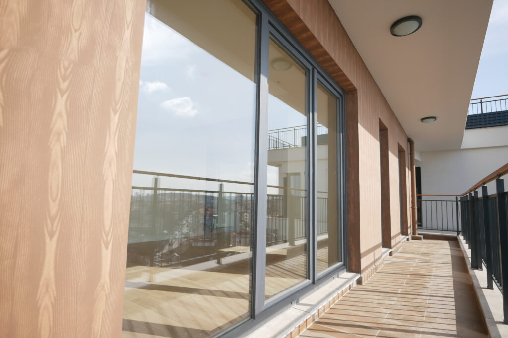 a modern apartment with a balcony, wooden deck, and glass doors offers luxurious living in the city